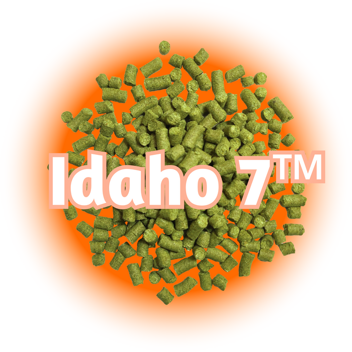 A pile of green US Idaho 7™ Hops pellets with the text 'IDAHO 7' above it, against an orange and yellow gradient background.
